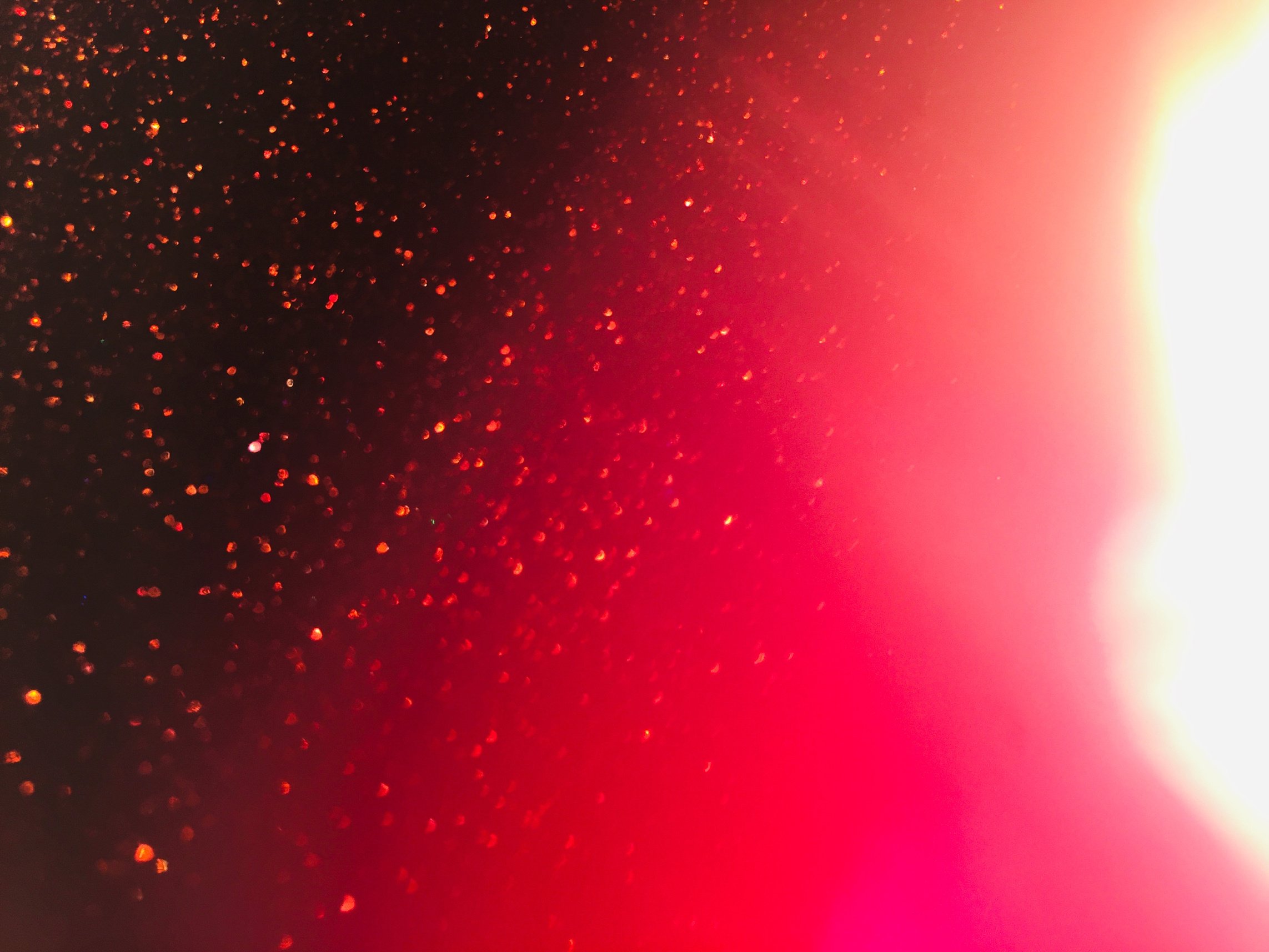 Red sparkle splash on red white gradient background